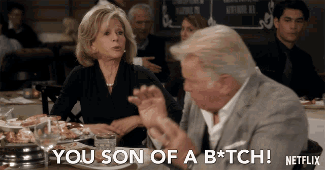 a man and a woman are sitting at a table and the man says you son of a b * tch netflix
