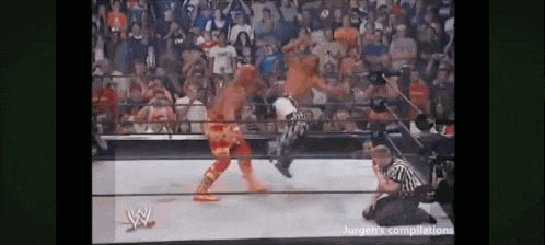 two men are wrestling in a wrestling ring with a referee watching .