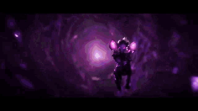 a person is standing in a dark room with purple lights coming out of it .