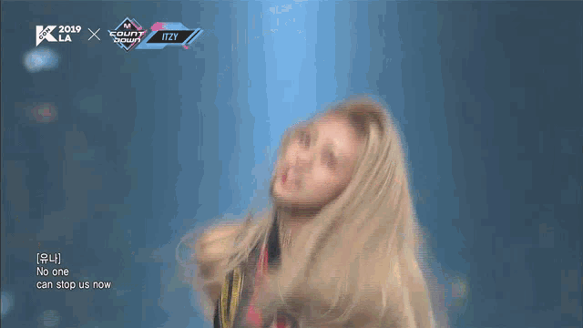 a woman performs on a stage with the words no one can stop us now in the lower right corner