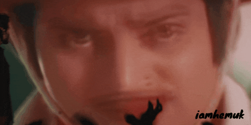 a close up of a person 's face with the name iamhemuk written below it