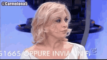 a woman in a white dress with the number 51665 on the bottom left