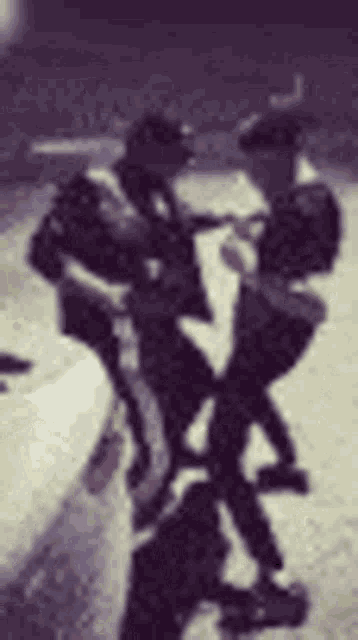 a blurry picture of a man sitting on a motorcycle .