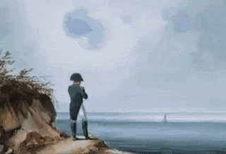 a man is sitting on top of a rock near the water .