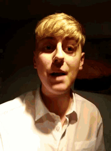 a man with blonde hair is wearing a white shirt and making a funny face