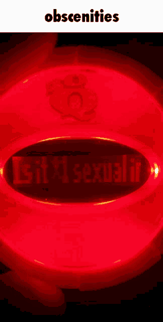 a close up of a red object that says obsceneities on it