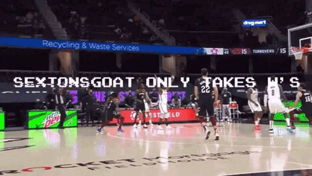 a basketball game is being played in front of a sign that says sextons goat only takes