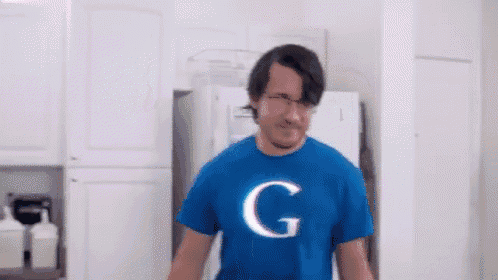 a man wearing a blue shirt with the letter g on it .