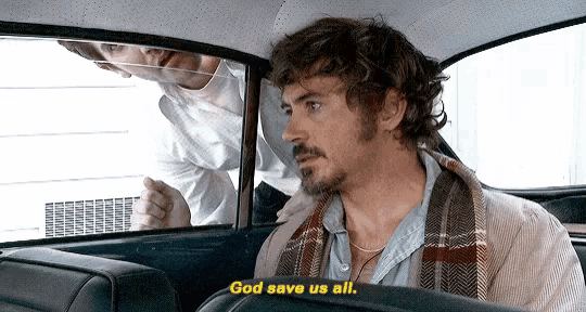 a man sitting in the back seat of a car says god save us all