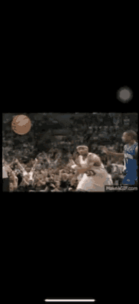 a basketball game is being played in front of a crowd of people