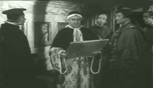 a man in a robe is holding a piece of paper