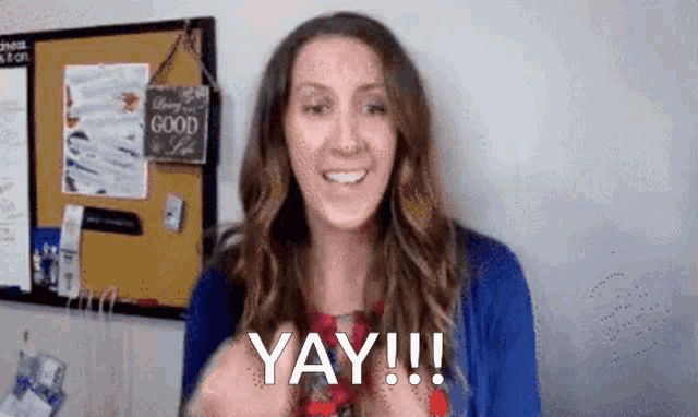 a woman is making a funny face and saying yay
