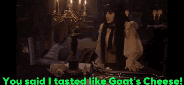 a woman sitting at a table with the words you said i tasted like goat 's cheese on the bottom