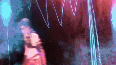a blurry picture of a person 's face with a purple and blue background