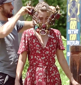 a man is helping a woman with a mask on her face