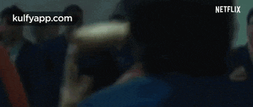 a blurry picture of a woman sitting in a chair in a movie theater .