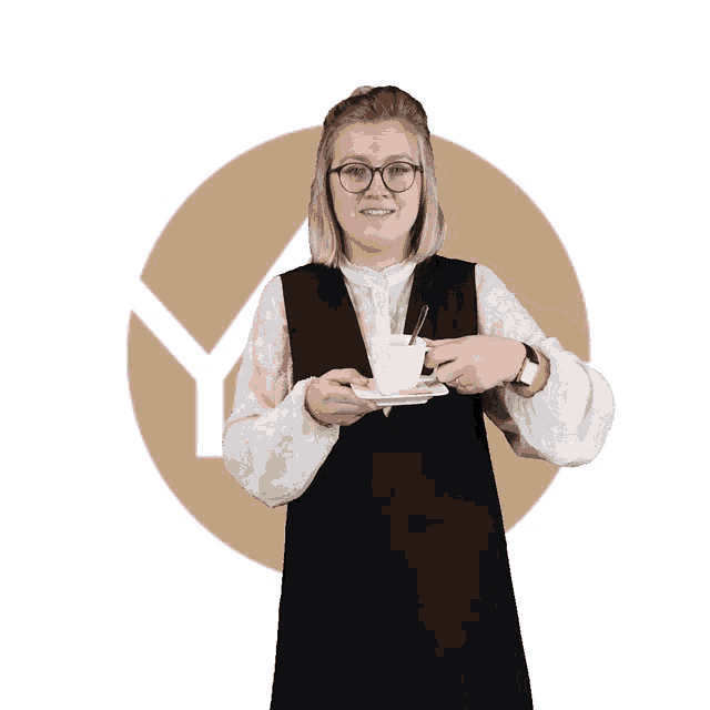 a woman holding a cup of coffee in front of a circle with the letter y