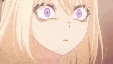 a close up of a girl with a ponytail and big eyes looking at something .