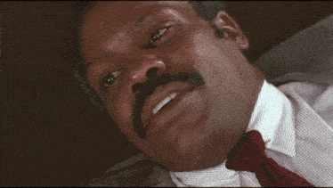 a man in a suit and tie is laying down with his eyes closed and the words i 'm too old for this shit below him