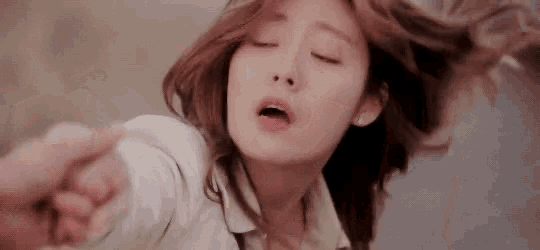 a close up of a woman 's face with her eyes closed .