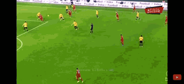 a soccer game is being played on a field that has a banner that says ' british breeze ' on it