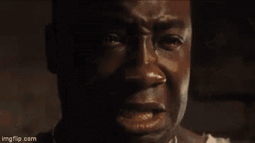 a close up of a man 's face with a tear running down his face .