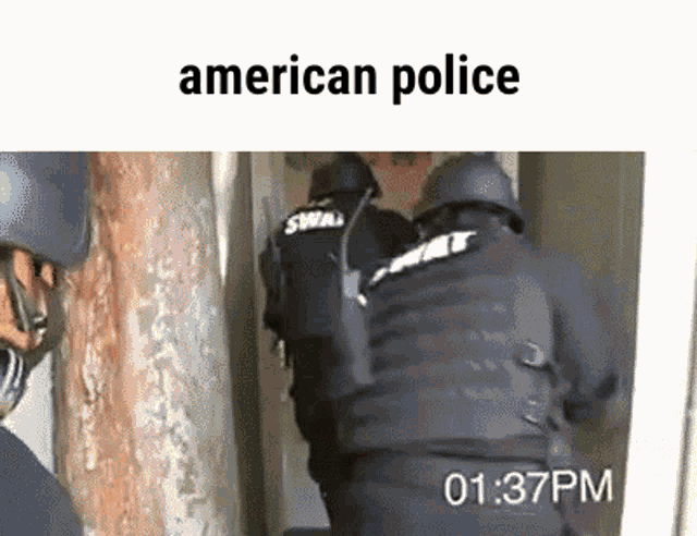 a group of american police officers are standing in a room .