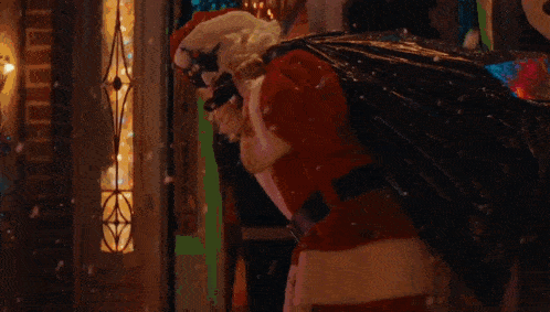 a scary clown wearing a santa hat with blood dripping from his face