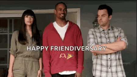 a group of people are standing next to each other in a room with the words `` happy friendiversary '' written on the screen .