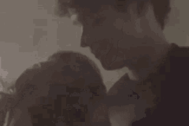 a man and a woman are hugging each other in a room .