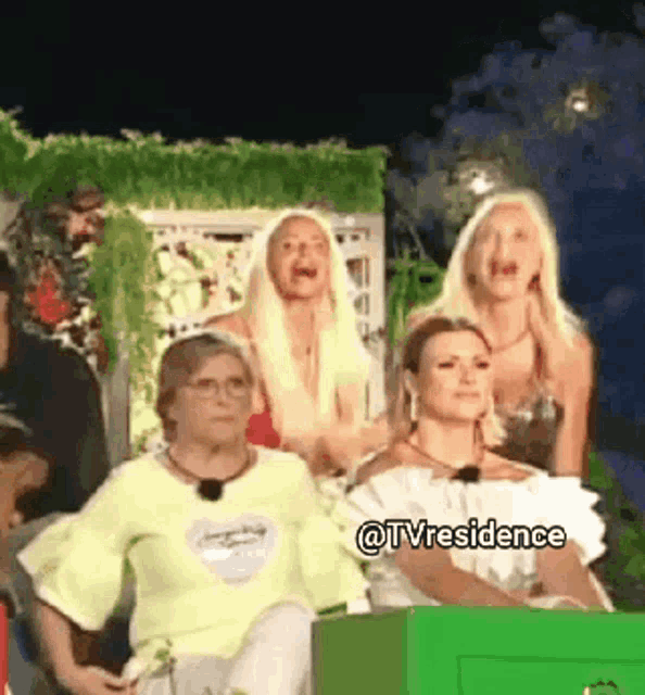 a group of women sitting in front of a green box with the words @tvresidence on the bottom