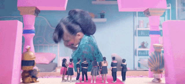 a girl with a bun on her head stands in front of a group of dolls