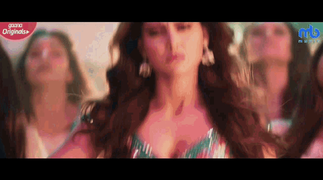 a woman is dancing in front of a sign that says ' originals '