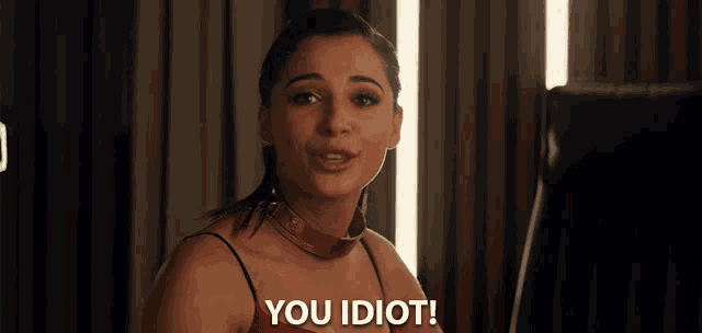 a woman with a choker on her neck says you idiot