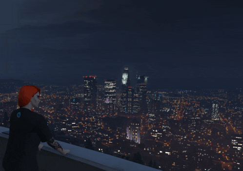a person with a tattoo on their arm is looking out over a city at night