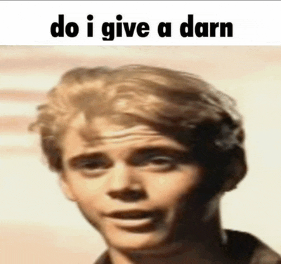 a close up of a man 's face with the words `` do i give a darn '' written above it .