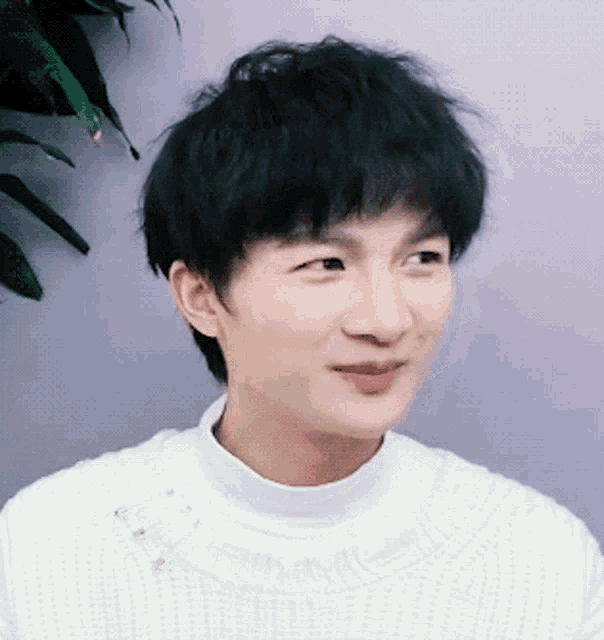 a close up of a person 's face with a white sweater on