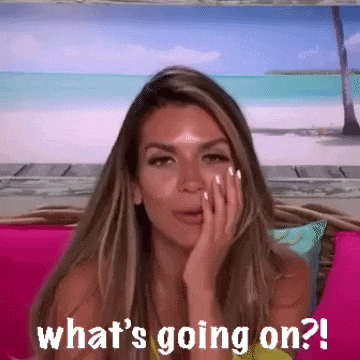 a woman is sitting on a pink couch with her hand on her face and the words what 's going on ?
