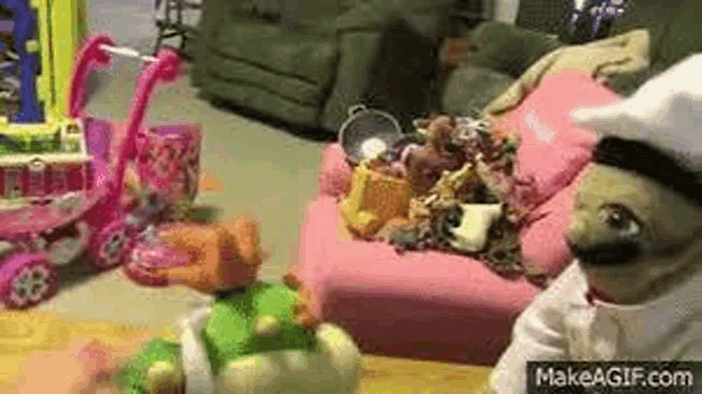 a stuffed animal in a chef 's hat is sitting on a pink couch .