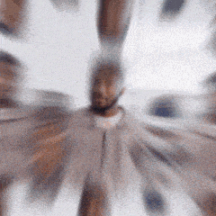 a blurry picture of a man with a beard in a circular pattern