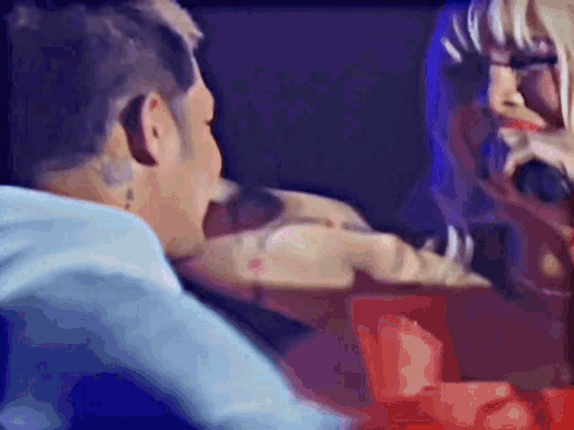 a man and a woman are looking at each other in a blurry photo