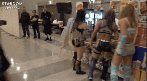 a group of women standing next to each other in a hallway with the word stardom on the bottom