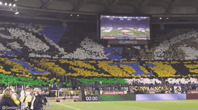 a soccer field with a large screen that says olimpico