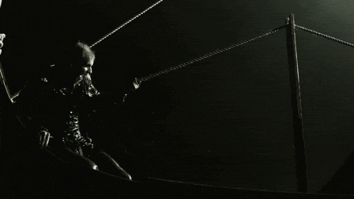 a man in a boat is holding a rope that says ' norwegian ' on it