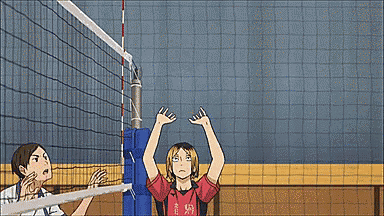 a group of people are playing volleyball on a court and one of them is wearing a red shirt .