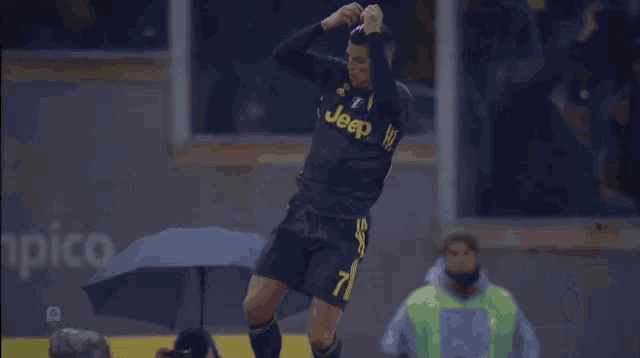 a soccer player wearing a black jersey with the word jeep on it