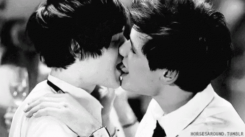 a black and white photo of two men kissing with the words horses around tumblr below them