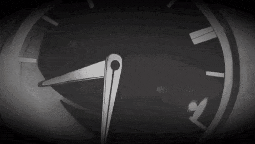 a black and white photo of a clock with the hands on the numbers 1 and 5
