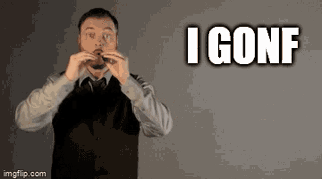 a man in a suit and tie is making a gesture with his hands that says i conf .