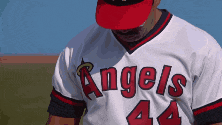 a man wearing a angels jersey with the number 44